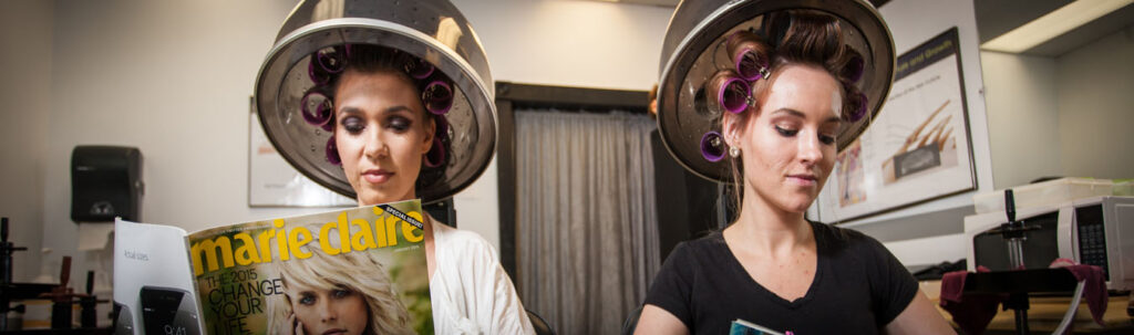 Ladies in curlers getting a perm.