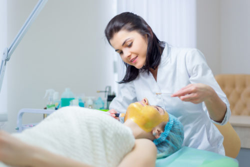 Esthetician giving woman a facial