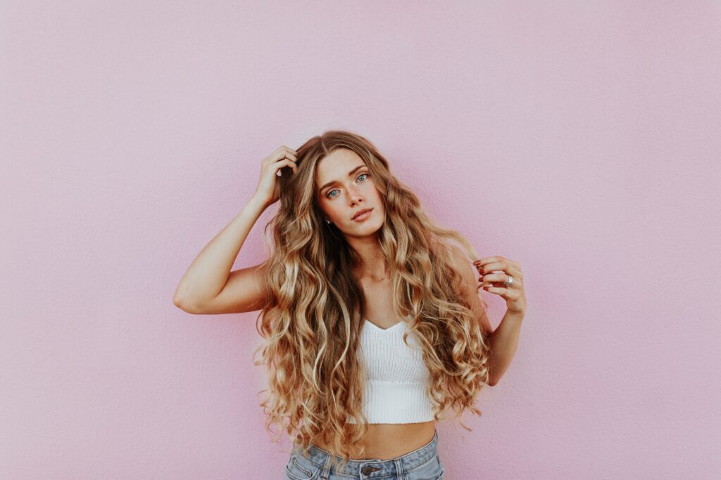 Model standing in front of pink wall