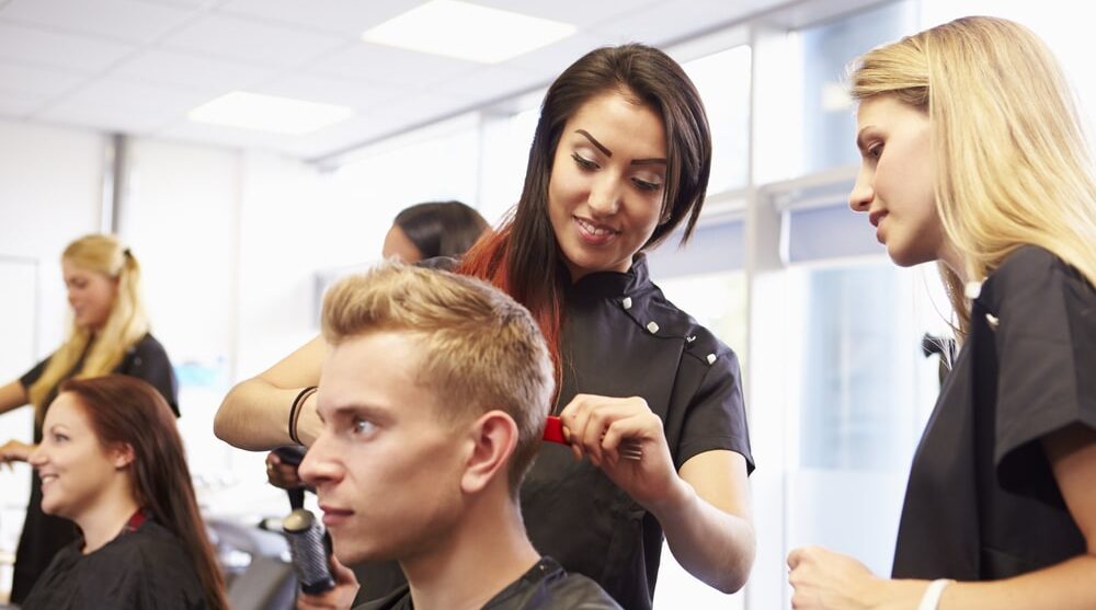 Instructor helping a beauty school student