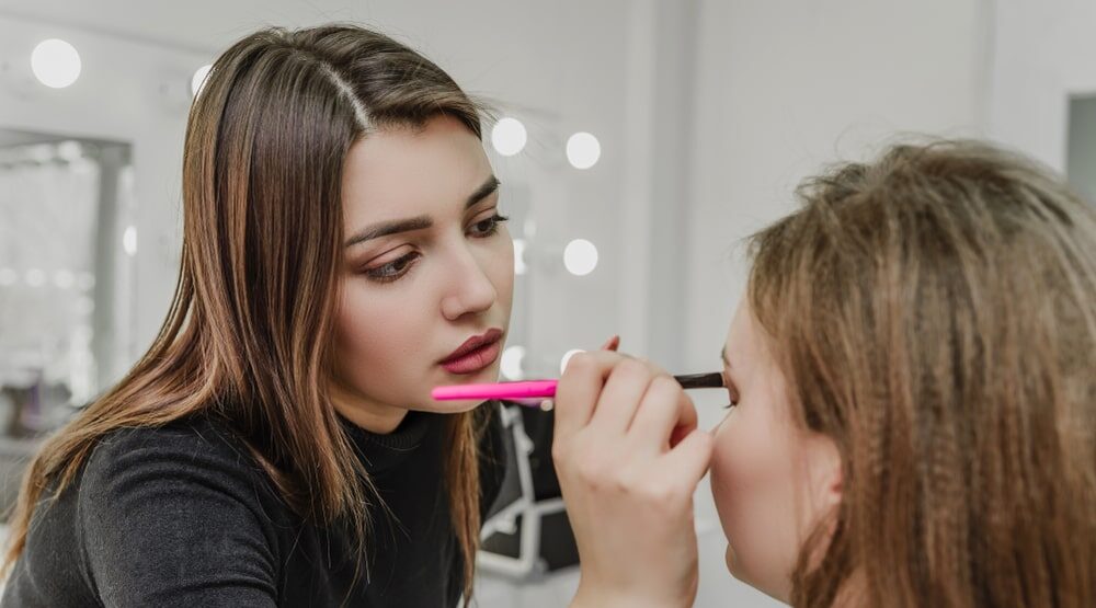 Woman applying makeup